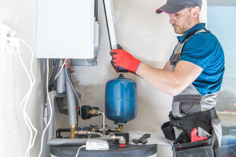 Heating engineer installing a central gas boiler