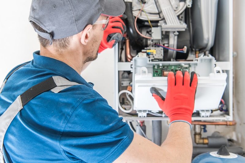 Gas engineer carrying out an annual boiler service